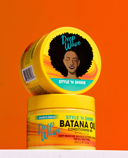 Two yellow haircare containers from Deep Wave Braider's Choice stacked on a white surface against a bright orange background. The top container shows the lid with an illustration of an afro and the text 'Style 'N Shine', while the bottom container reads 'Style 'N Shine Batana Oil Conditioning Oil'.