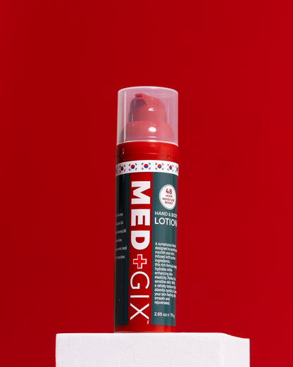 A red and green pump bottle of MED+GIX Hand & Body Lotion standing on a white pedestal against a solid red background.