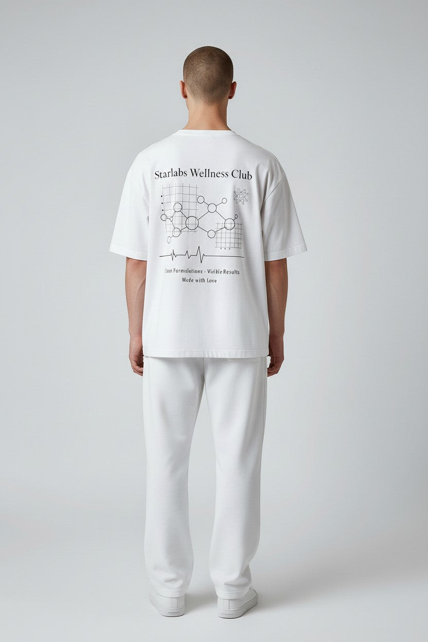 Person wearing a white t-shirt with 'Starlabs Wellness Club' design on a plain background
