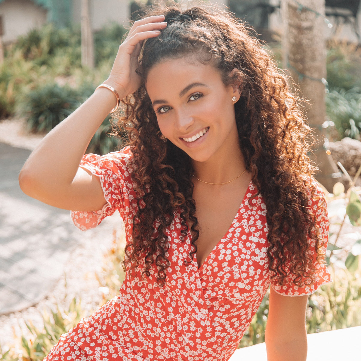 Women’s red floral cotton dress with puff sleeves, outdoor sunny portrait
