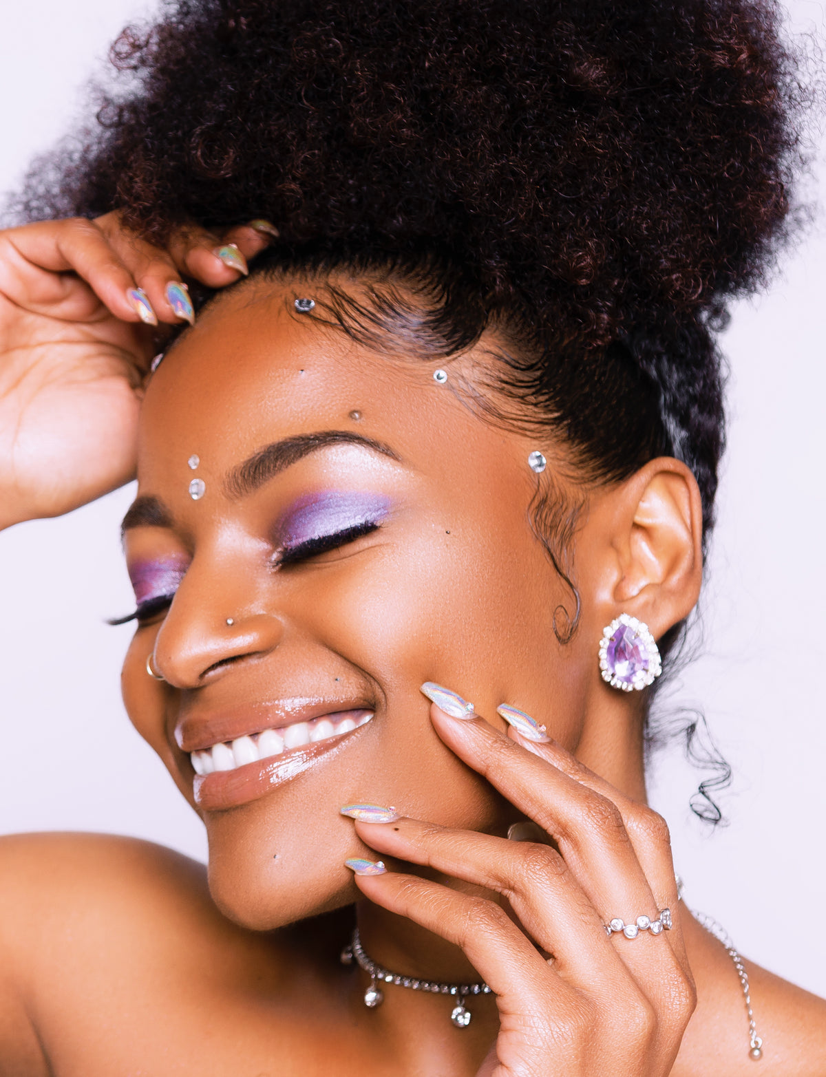 Woman with short curly hair as a hand applies hair gel for hair braiding, close up on face and scalp